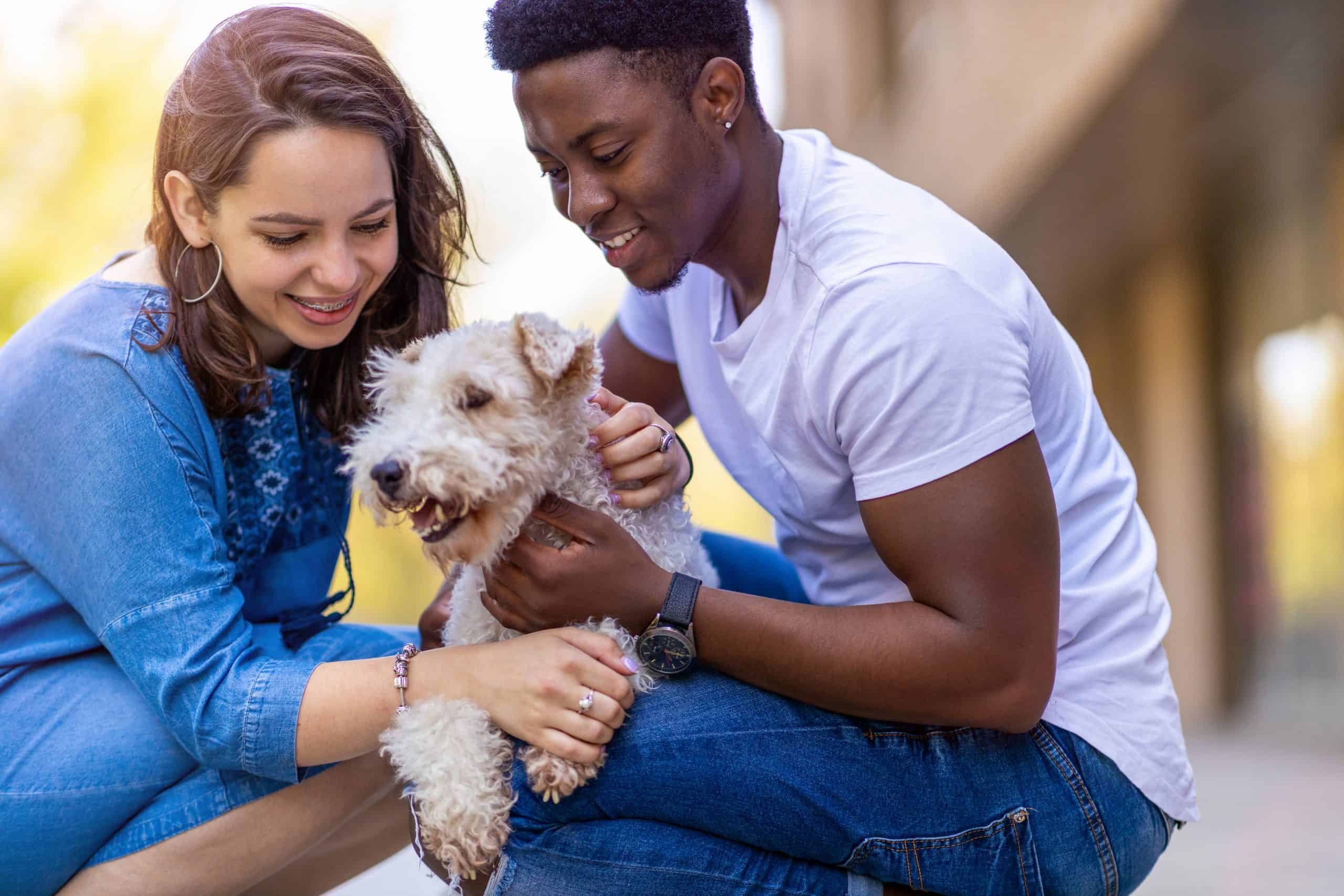 Happy-young-couple-with-pet-dog